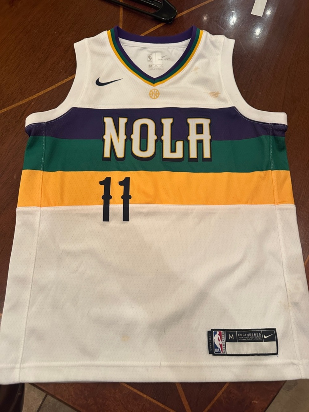 Nike White NOLA Basketball Jersey with Purple, Green & Gold Stripes